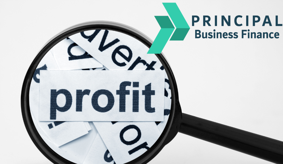 Magnifying glass over paper with the word profit in bold